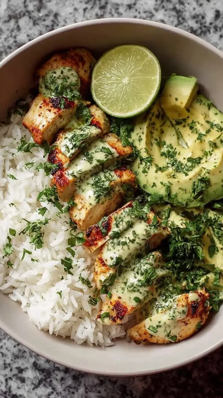 Seared cilantro lime chicken strips served over jasmine rice with sliced avocado and lime wedges