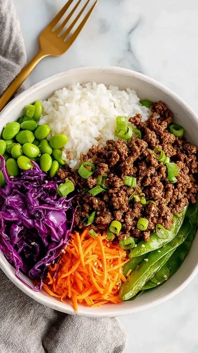 A colorful meal prep container filled with glazed teriyaki beef, fluffy jasmine rice, and bright green steamed broccoli.