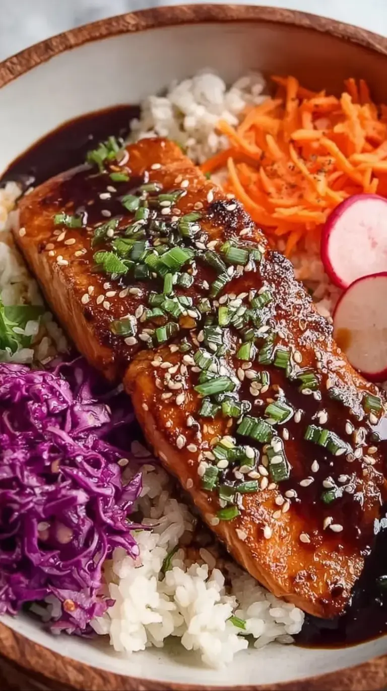 A colorful Teriyaki Salmon Bowl with crispy salmon, green broccoli, and orange carrots over white rice.